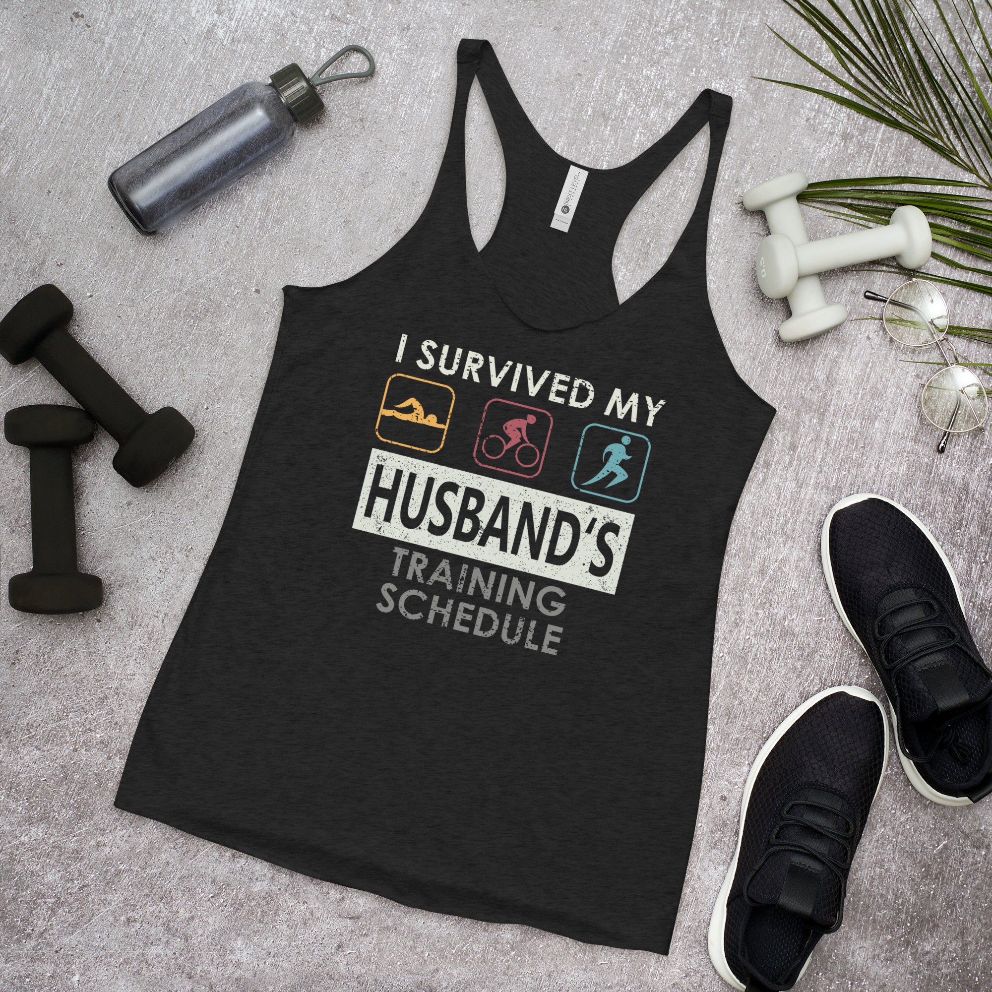 Survived my Husband39s Training Schedule Triathlete Tank Top Racerback Tank Top – Soft Feel · Trending Graphic Apparel