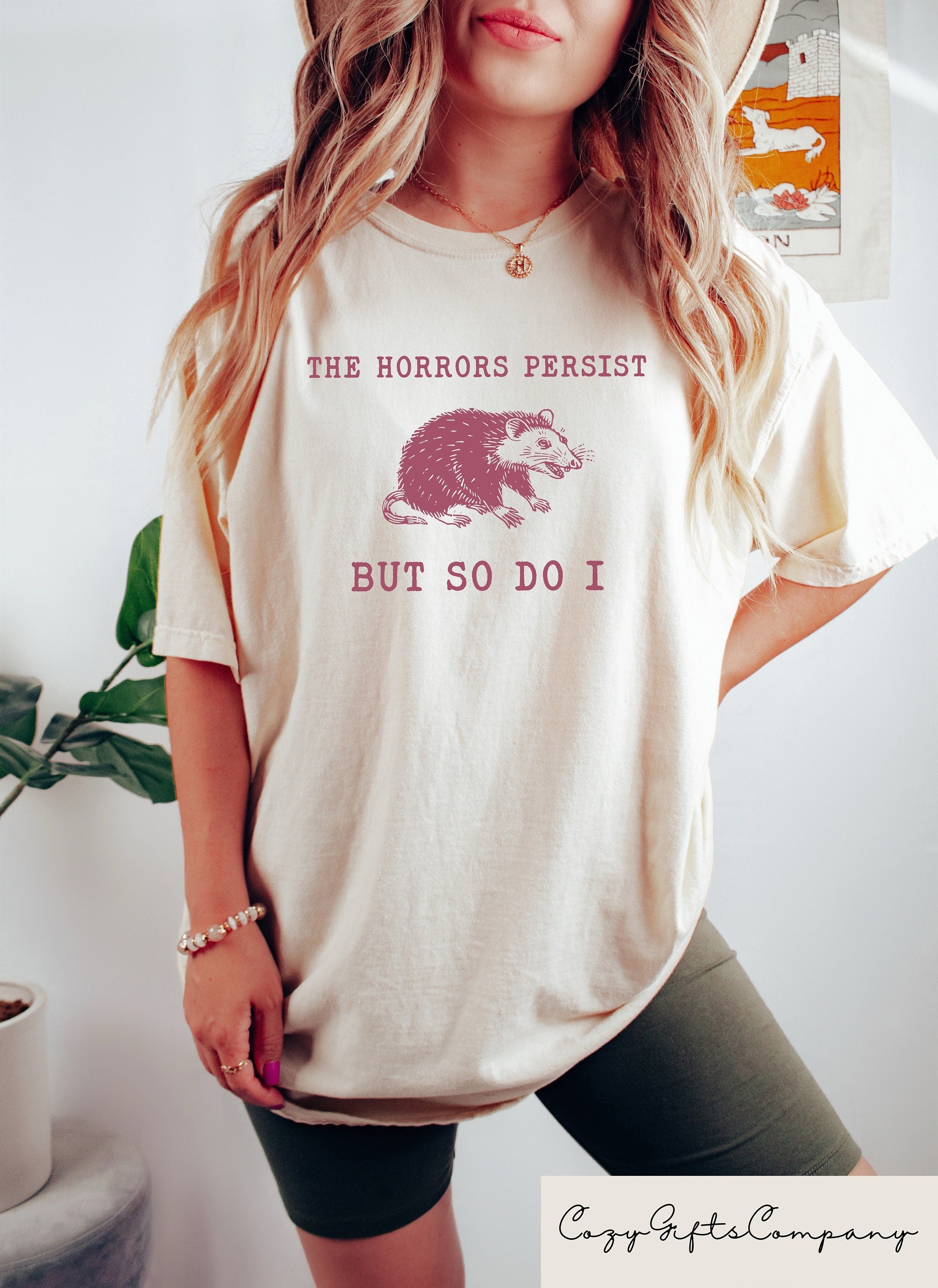 The Horrors Persist But So Do I Sarcastic Shirts Funny Mental Health Meme Shirt Raccoon Gift Raccoon Sweatshirt Trendy Woman Clothing Sweatshirt – Everyday Comfort · Great Gift For Fans