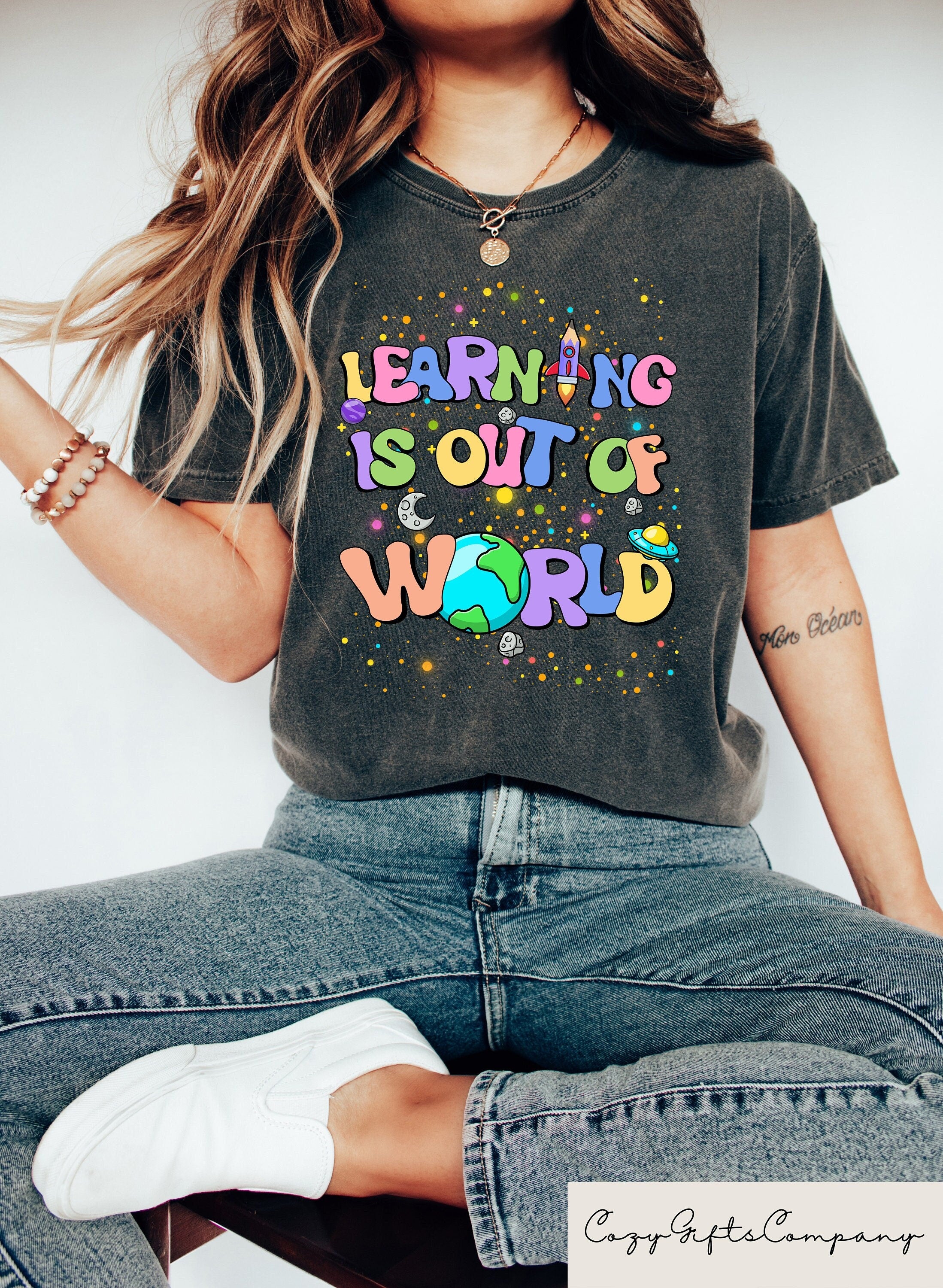 Learning Is Out Of World Tee Solar System Teacher Shirt Back To School GIft Outer Space Science Teacher Tee Teacher Appreciation Graphic Tee – Aesthetic Look · Trending Graphic Apparel