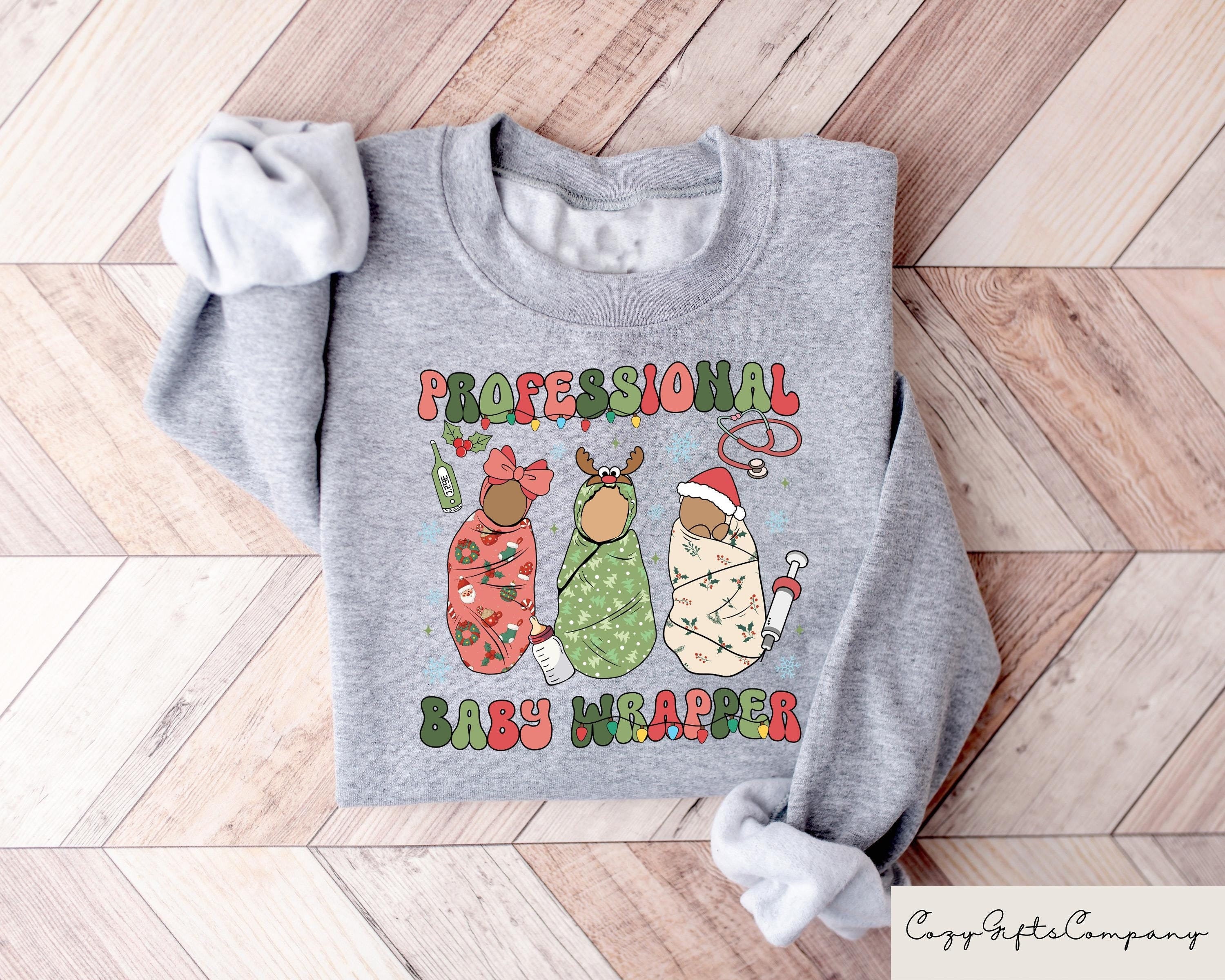 Labor And Delivery Christmas Sweatshirt Professional Baby Wrapper LD Nurse Christmas T Shirt Labor Nurse Gifts Xmas Nurse Specialist Tee Sweatshirt – Aesthetic Look · Great Gift For Fans