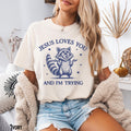 Christian Jesus Loves You And I39m Trying Raccoon Y2K Meme Funny Trendy Weird Silly Retro Bible Verse Faith Gift Graphic Tee – Premium Graphic · Great Gift For Fans