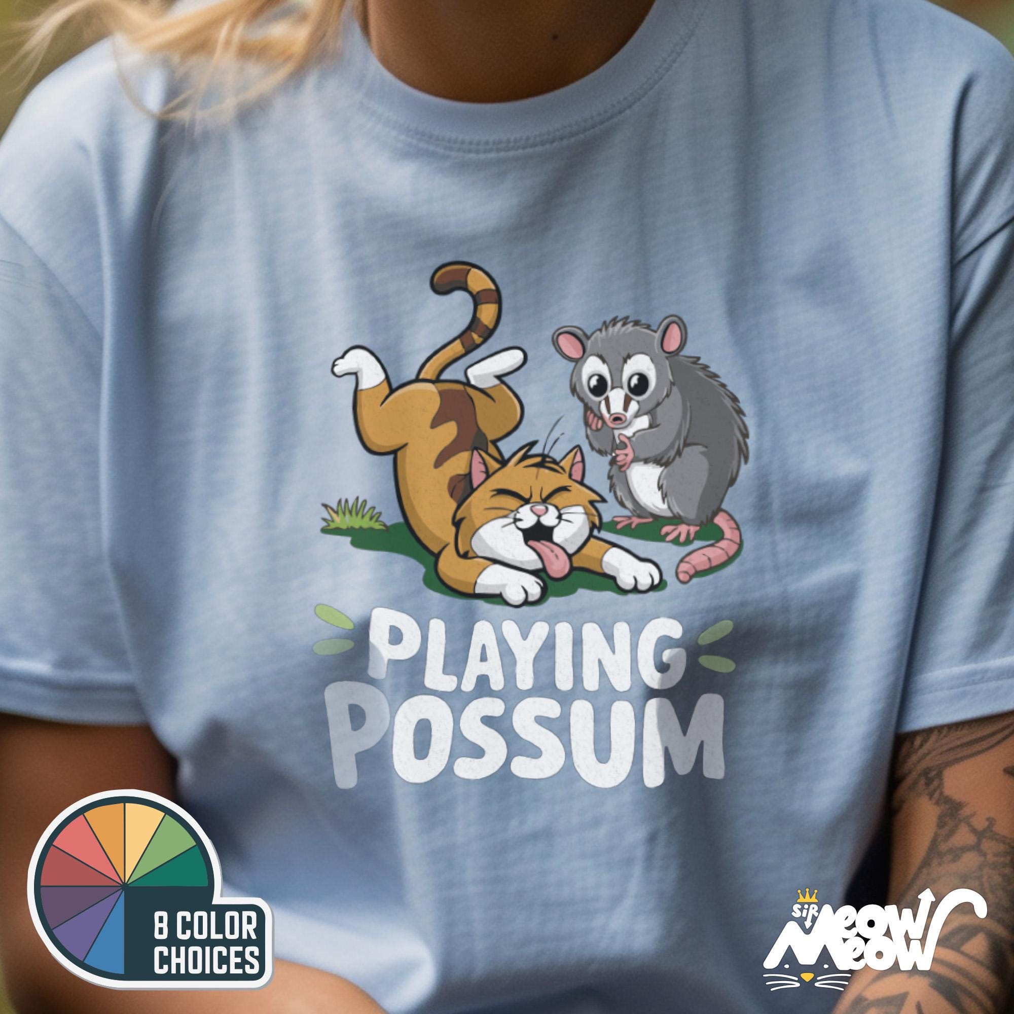 Playing Possum Funny Cat and Opossum T Shirt Cute Animal Humor Gift Graphic Tee – Premium Graphic · High-Quality Print