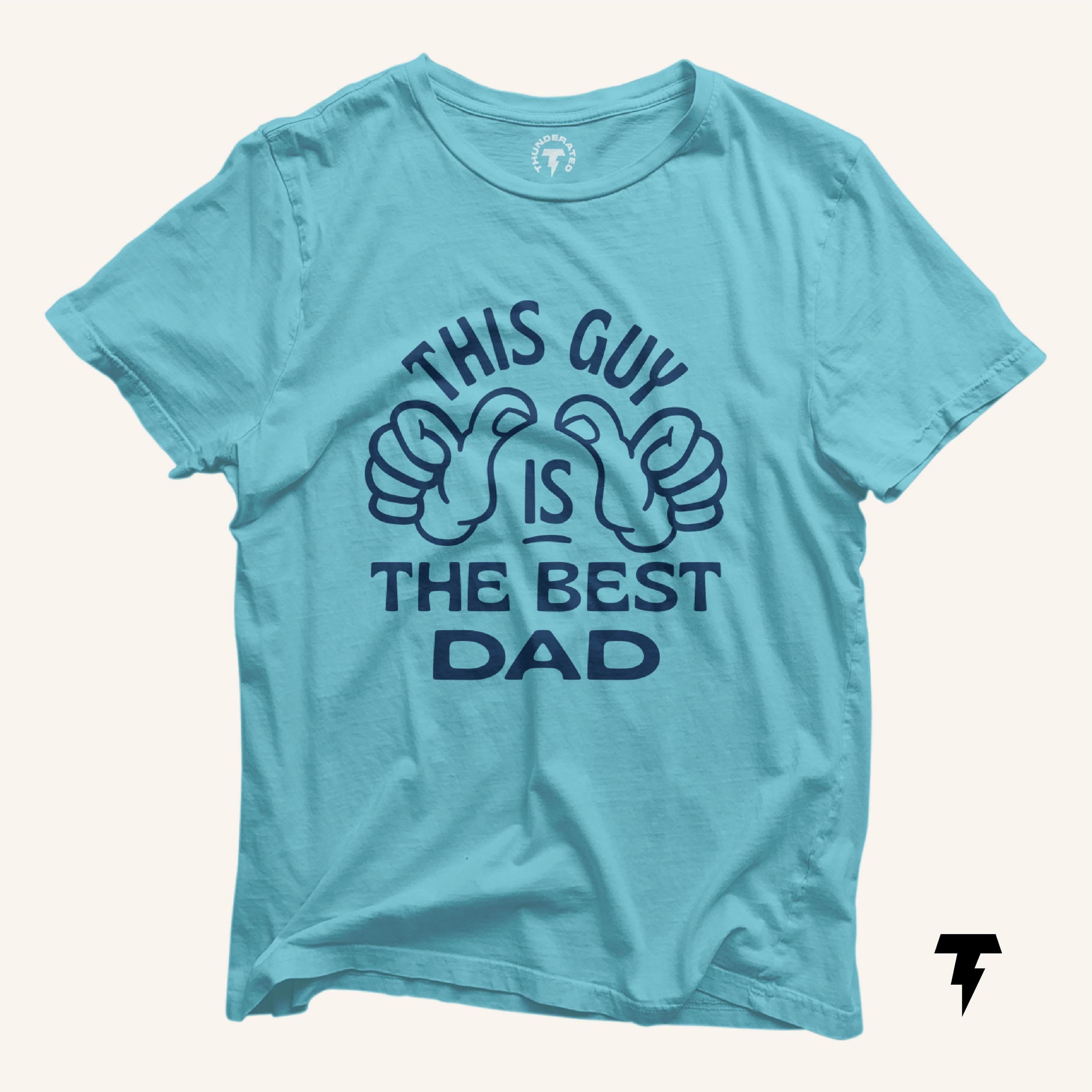 This Guy is the Best Dad Shirt Gift for Husband Funny Father Shirt Daughter or Son Gift for Dad Thumbs Pointing Gag Gift Dad Humor Tee Graphic Tee – Premium Graphic · Trending Graphic Apparel