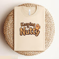Keeping It Nutty Funny T Shirt Cute Peanut Cartoon Graphic Tee Humorous Foodie Shirt for Nut Lovers Unisex T Shirt Gift Funny Saying Tee Graphic Tee – Aesthetic Look · Top Pick For Any Outfit