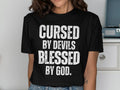 Cursed By Devils Blessed By God T shirt Inspirational Graphic Tee Motivational Quote Shirt Spiritual Statement Top Unique Gift Idea Graphic Tee – Fan Favorite · Perfect For Daily Wear