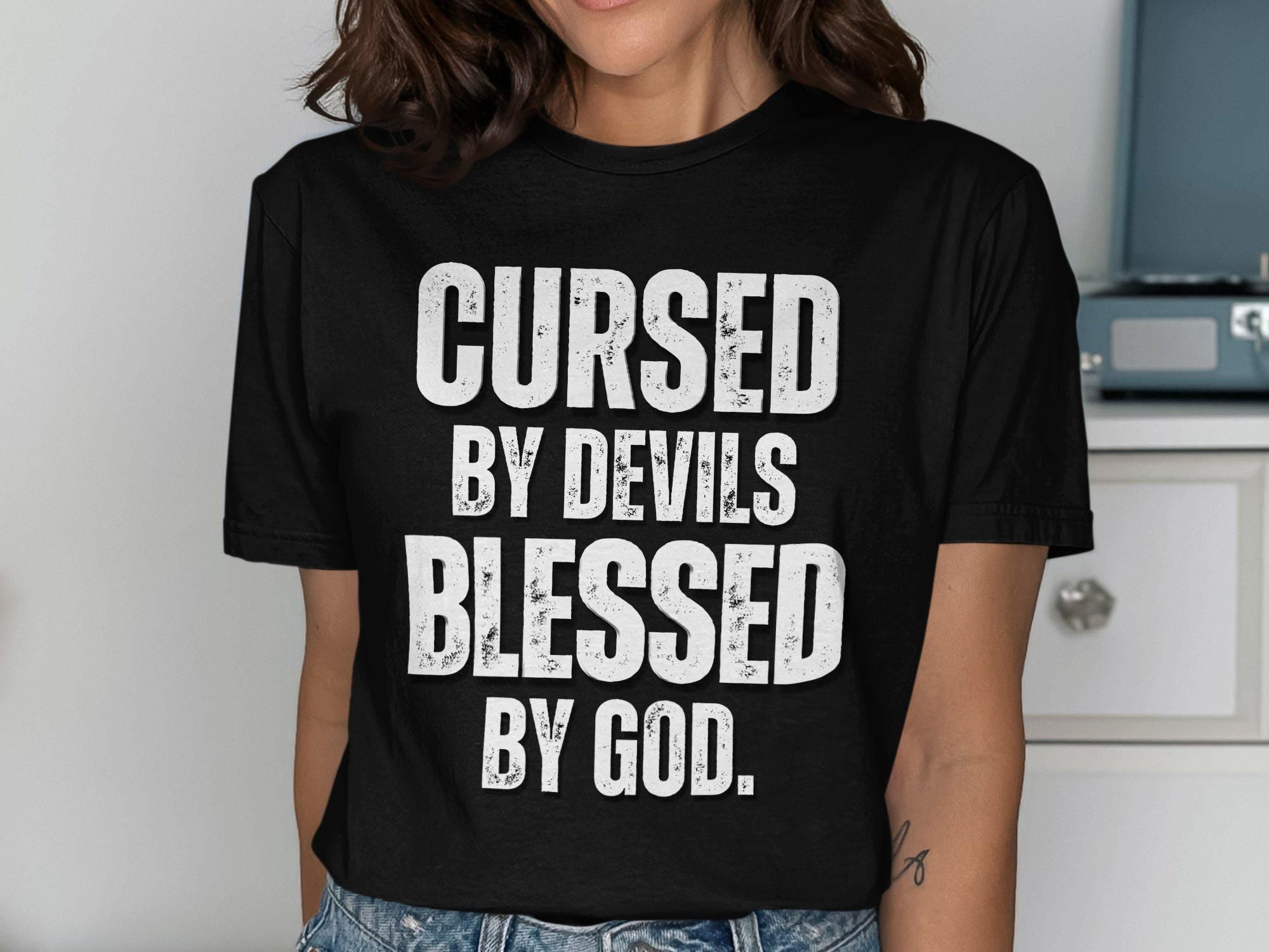 Cursed By Devils Blessed By God T shirt Inspirational Graphic Tee Motivational Quote Shirt Spiritual Statement Top Unique Gift Idea Graphic Tee – Fan Favorite · Perfect For Daily Wear