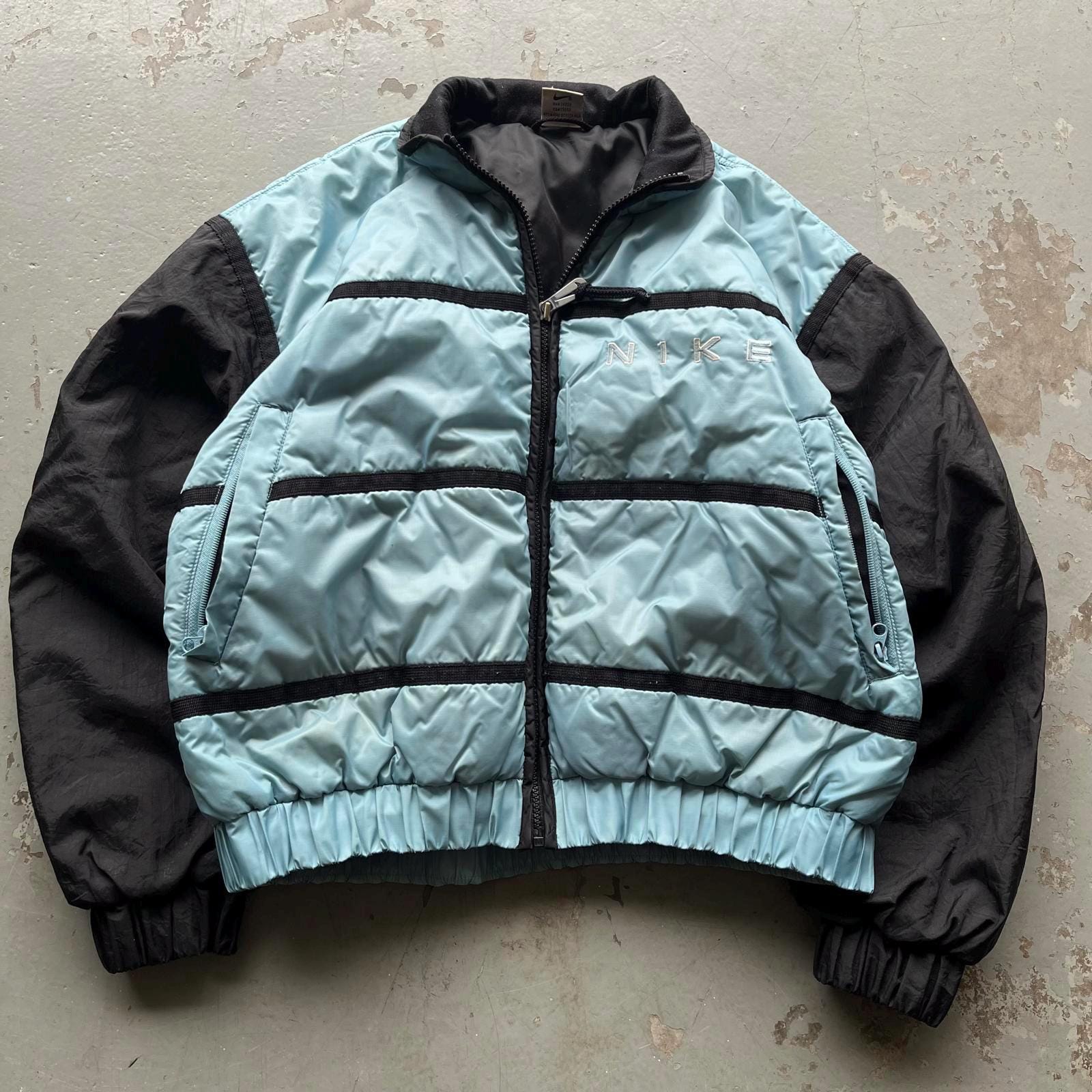 Vintage 90s Baby Blue Nike Puffer Grunge Sports Jacket Graphic Tee – Soft Feel · Trending Graphic Apparel