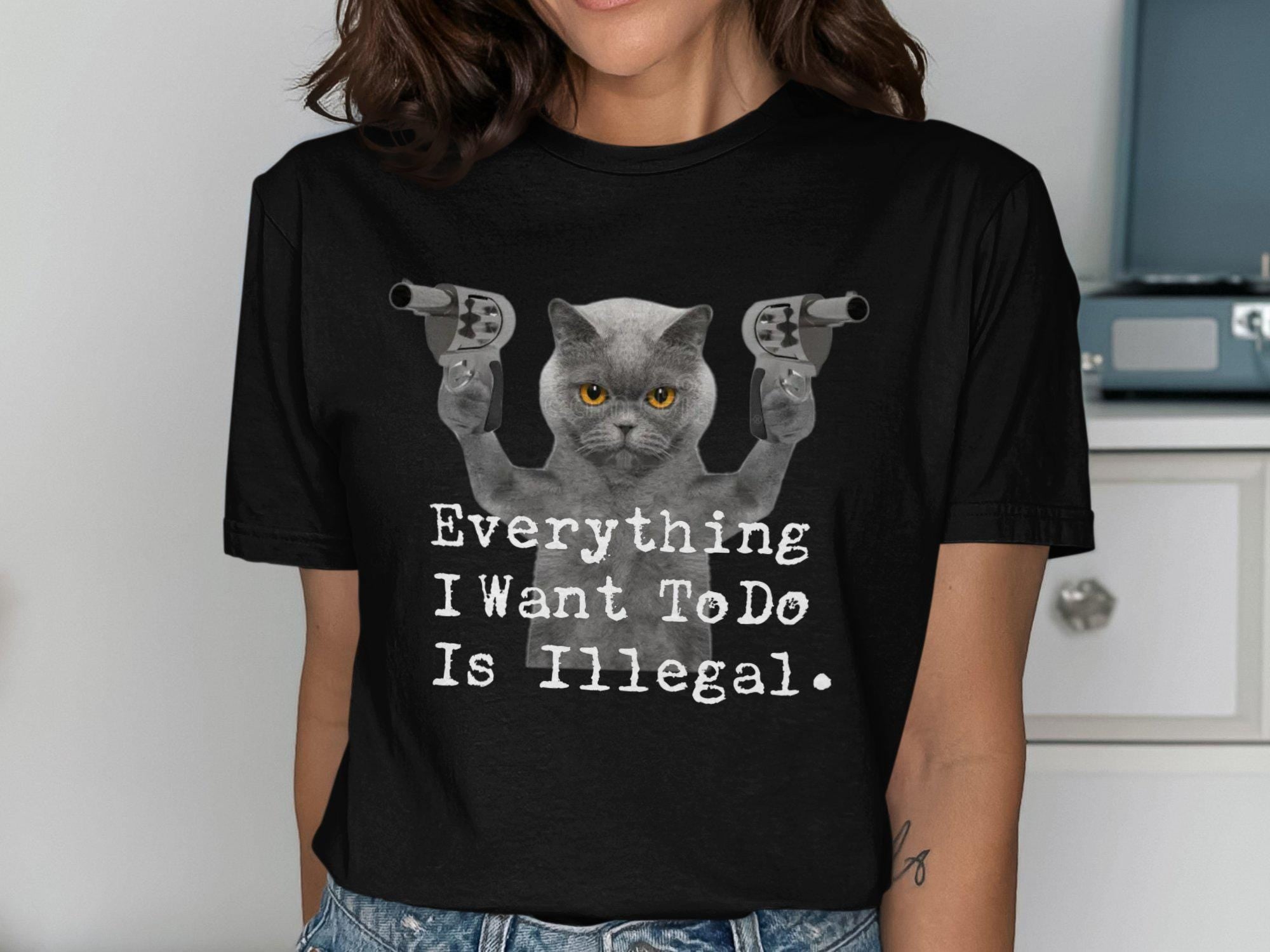 Funny Cat with Guns Graphic Tee Everything I Want To Do Is Illegal T Shirt Humorous Cat Lover Gift Cute Cat Meme Shirt Novelty Tee Graphic Tee – Aesthetic Look · Great Gift For Fans