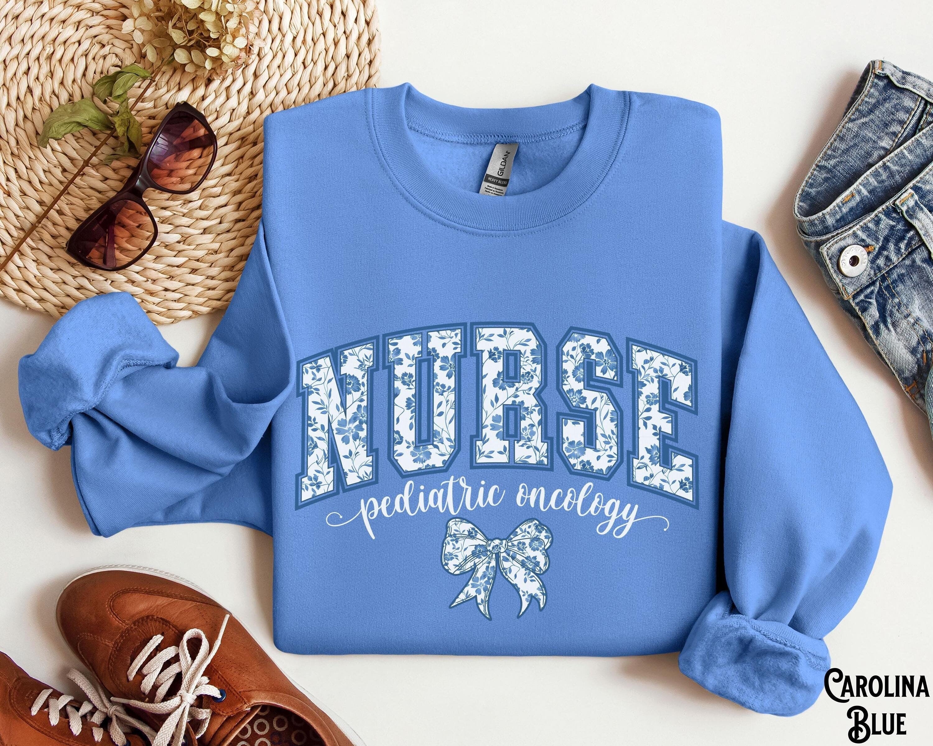 Pediatric Oncology Sweatshirt PEDS ONC Varsity Sweater Nurse Crew Coquette Bow RN Cancer Nurse Crewneck Hematology Nursing Gift Sweatshirt – Warm & Stylish · Great Gift For Fans