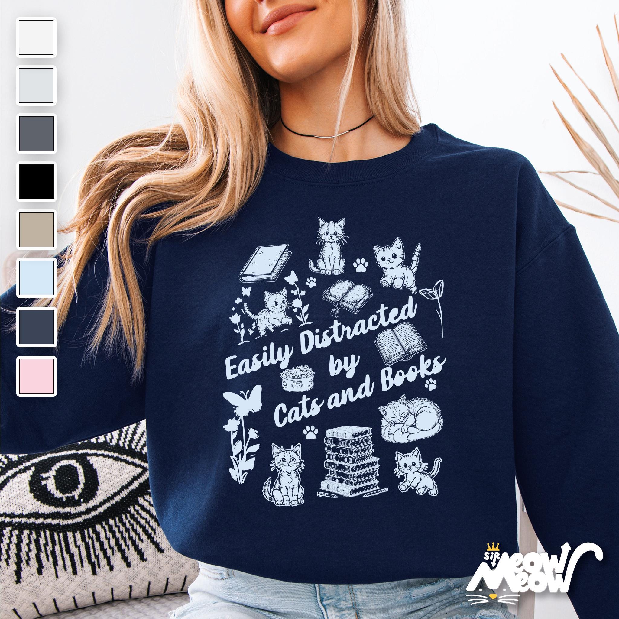 Easily Distracted by Cats and Books Sweatshirt Cute Cat Book Lover Crewneck Cozy Gift for Readers and Feline Fans Sweatshirt – Bold Style · Trending Graphic Apparel