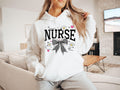 Nurse Sweatshirt with checkered bow Cozy Crewneck for Nurses Gift for Healthcare Workers Appreciation Day Apparel Medical Job Hoodie Hoodie – Easygoing Wear · High-Quality Print