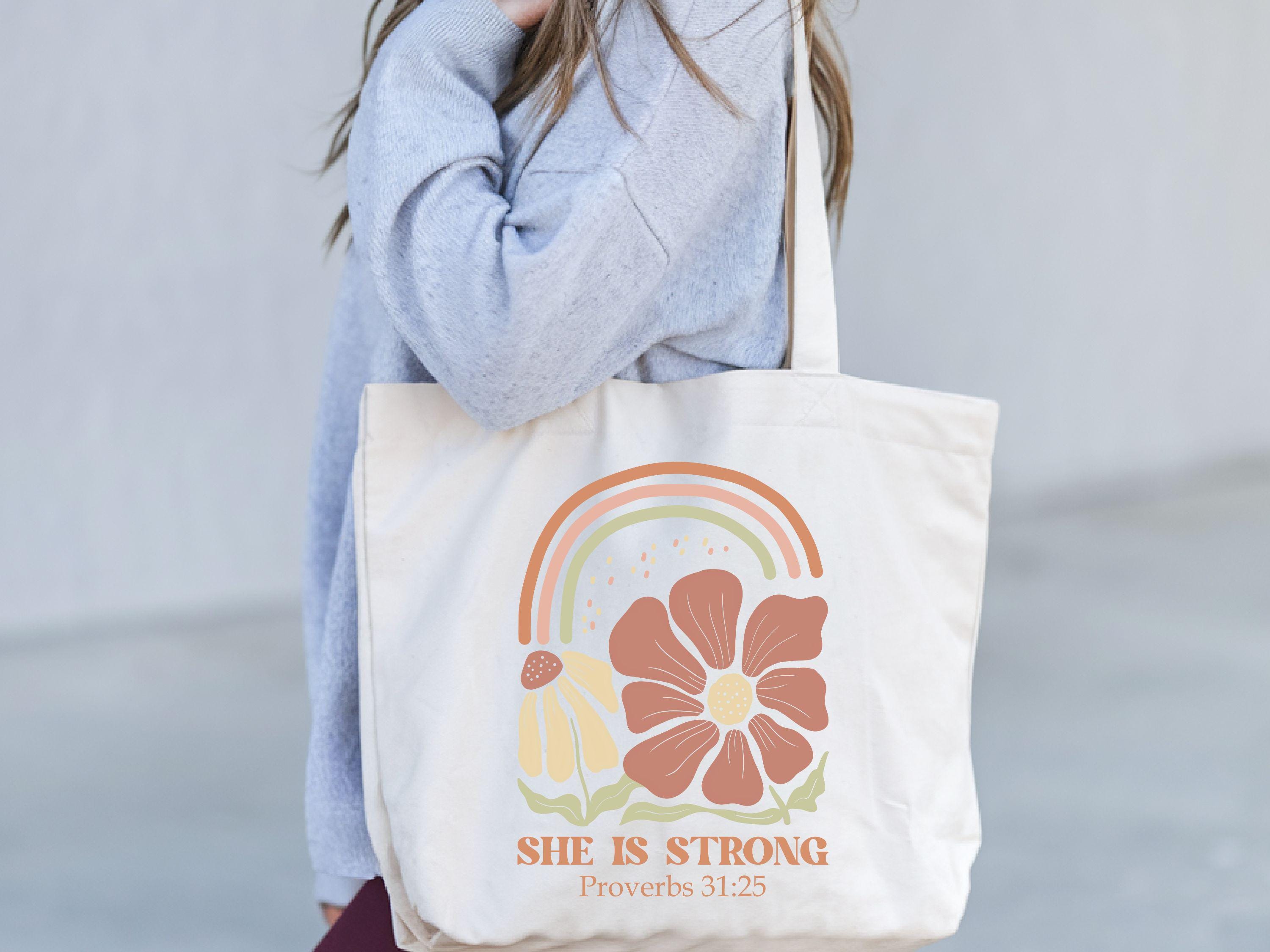 She Is Strong Wildflower Tote Bag Gift for Moms Mothers Day Gift Christian Mom Bag Boho Floral Bible Bag Positive Faith Bag Mama Bag Tote Bag – Premium Graphic · Trending Graphic Apparel