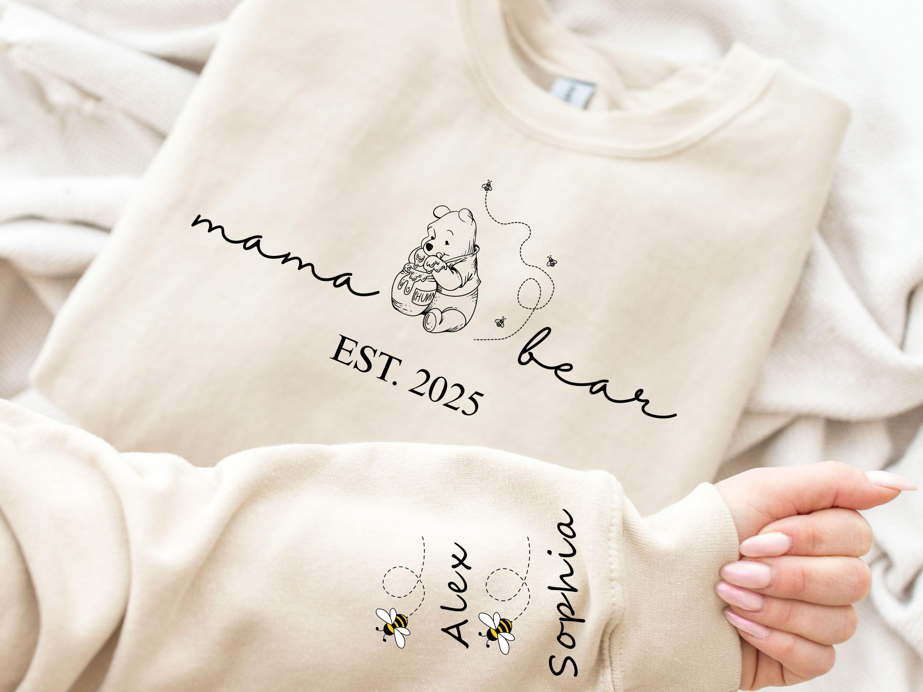 Custom Mama Bear Hoodie and Sweatshirt Mother Day Gift Winnie the Pooh Mothers Days Gift Mama Est with Kid Name on Sleeve Classic Shirt Hoodie – Premium Graphic · Trending Graphic Apparel