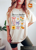 Retro Comfort She Is A Teacher T shirt Aesthetic Teacher Shirt Coquette Bow Teacher Gift Woman School Outfit Teacher Appreciation Tee Graphic Tee – Bold Style · High-Quality Print