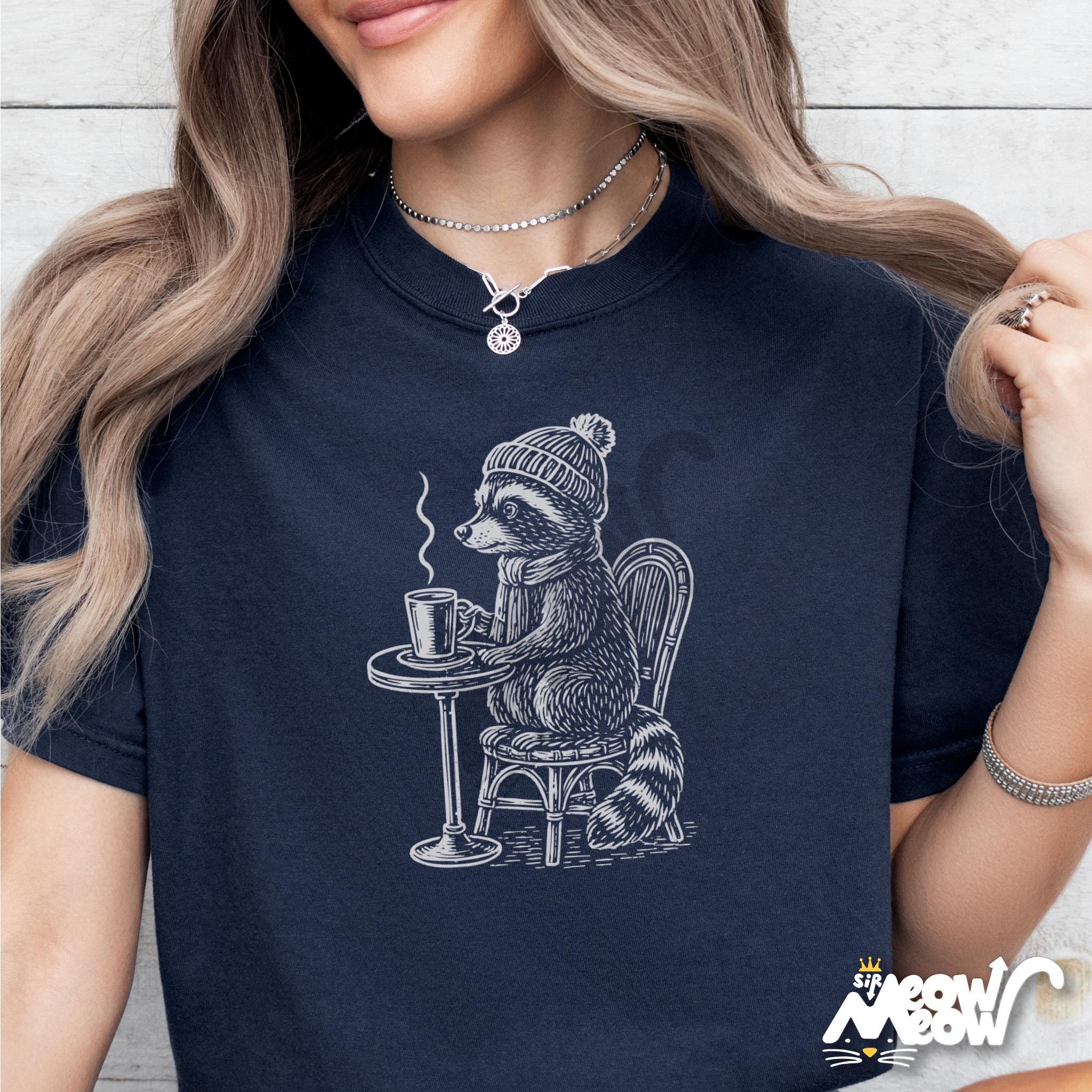 Caf Raccoon T Shirt Cozy Coffee Animal Tee Hipster Woodland Critter Shirt Autumn Winter Vibes Graphic Tee – Everyday Comfort · Trending Graphic Apparel
